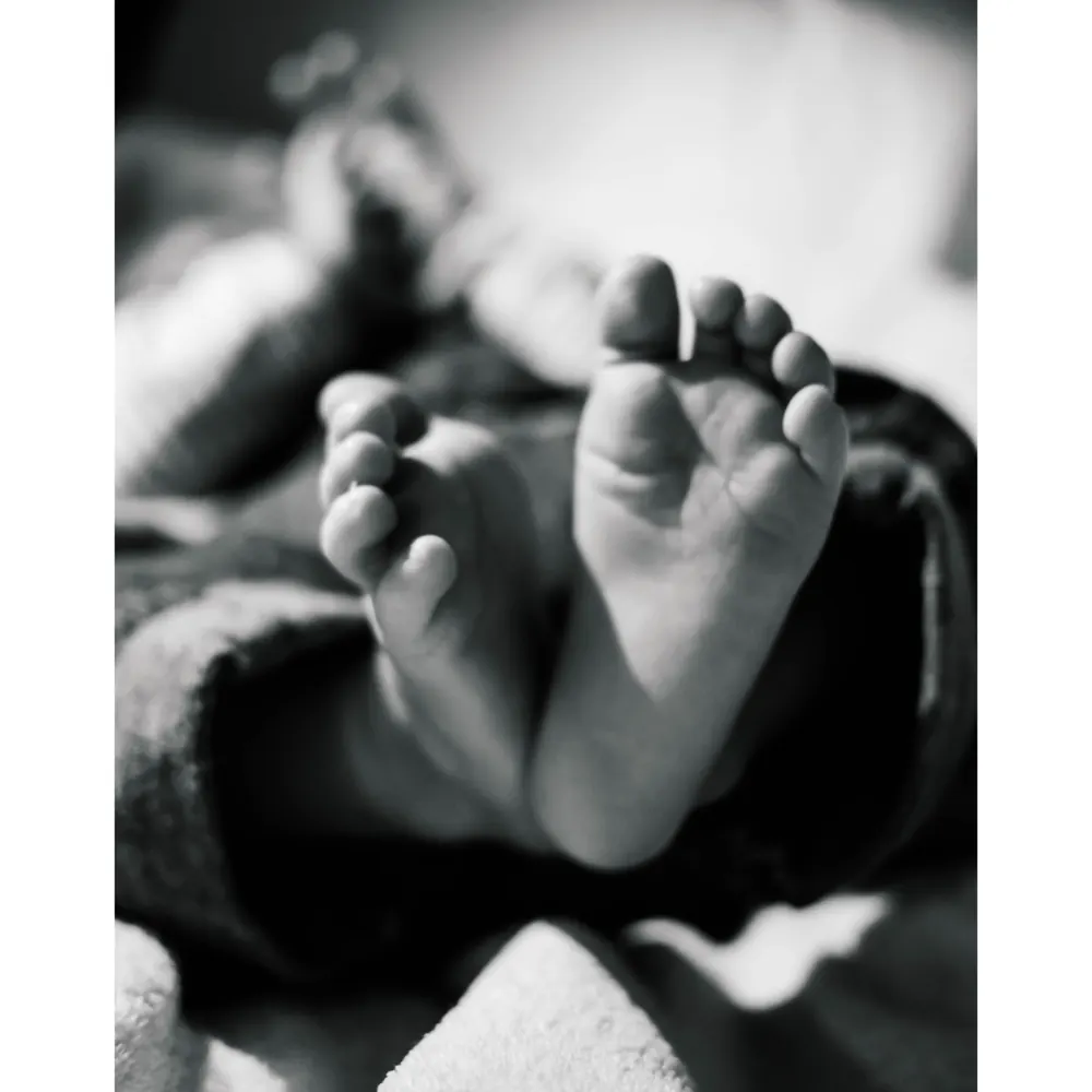 Black and white photo of a newborn's tiny feet